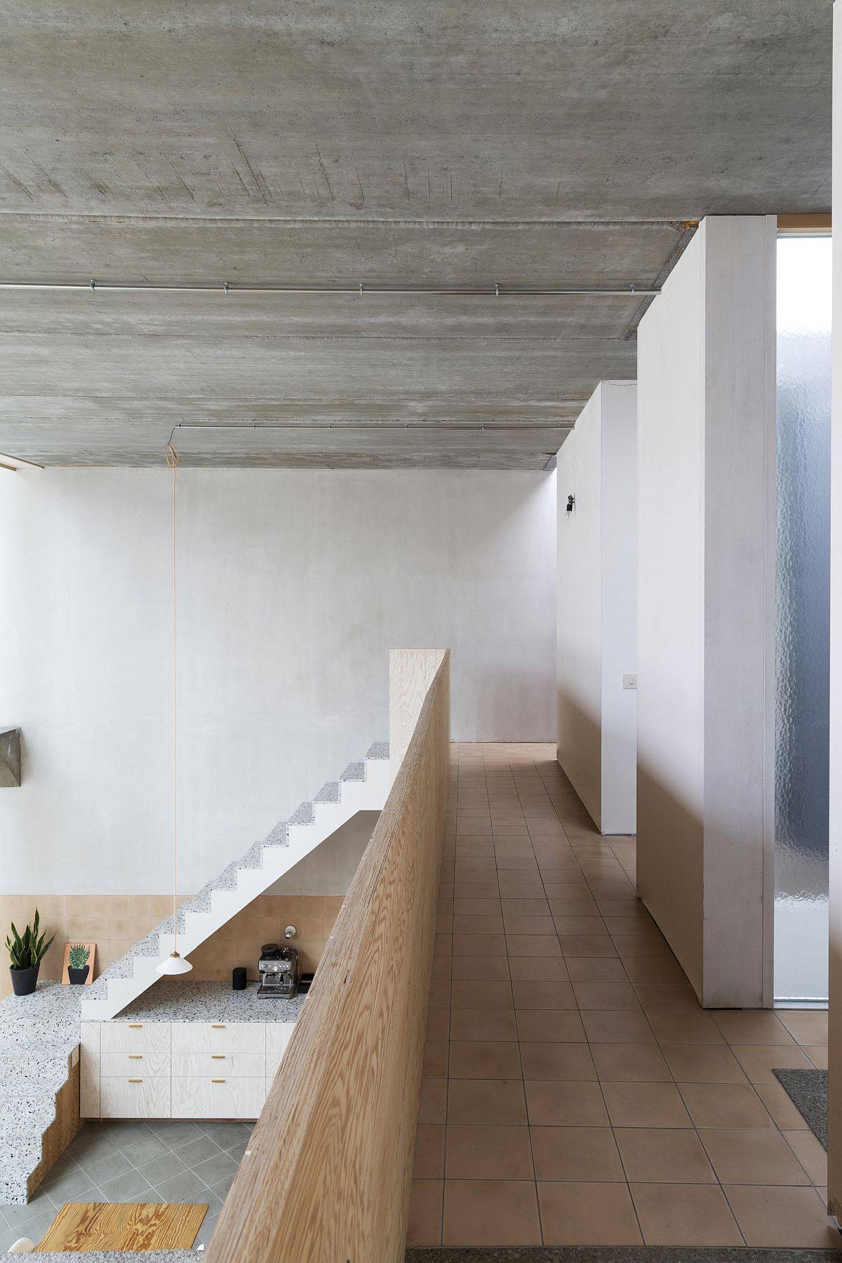 Interior of the adaptive home clad in concrete, wood and mosaic