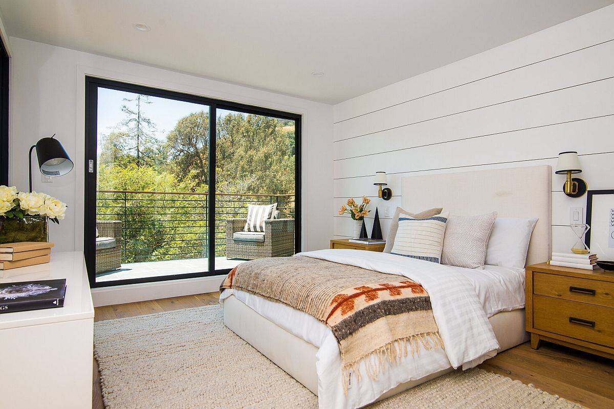 Modern beach style bedroom in white with cozy textiles and ample natural light