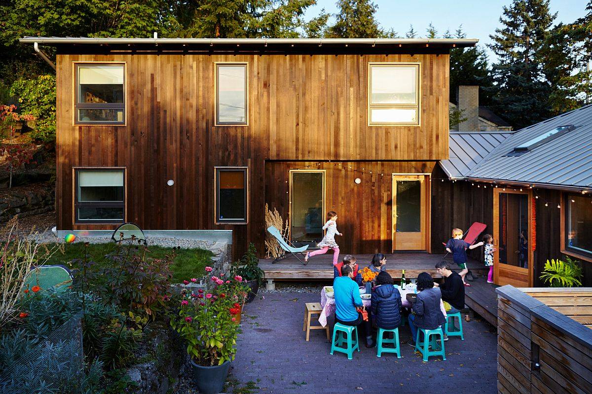 Modern extension with an exterior wrapped in vertical cedar stads as backdrop to the fabulous new courtyard