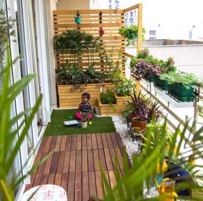 faux grass on balcony with plants and colorful accents