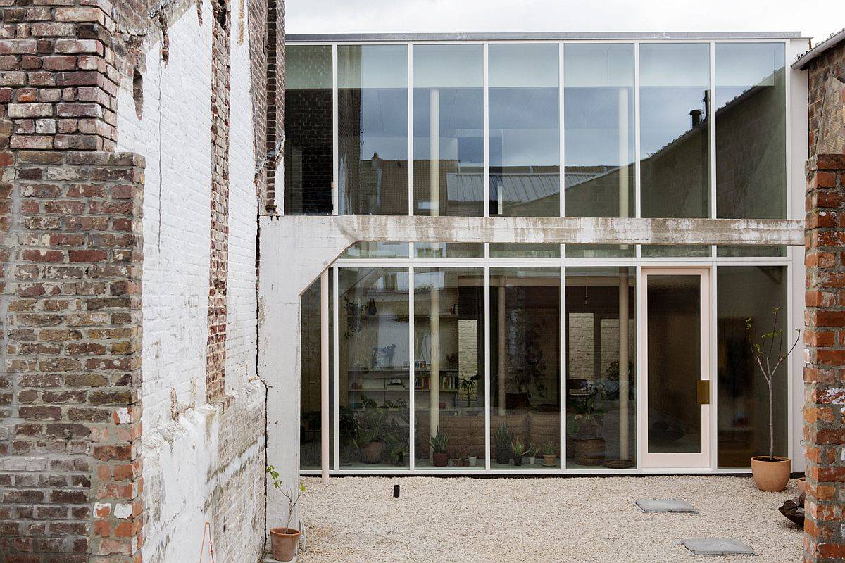 Sliding glass doors connect the interior with the garden area outside