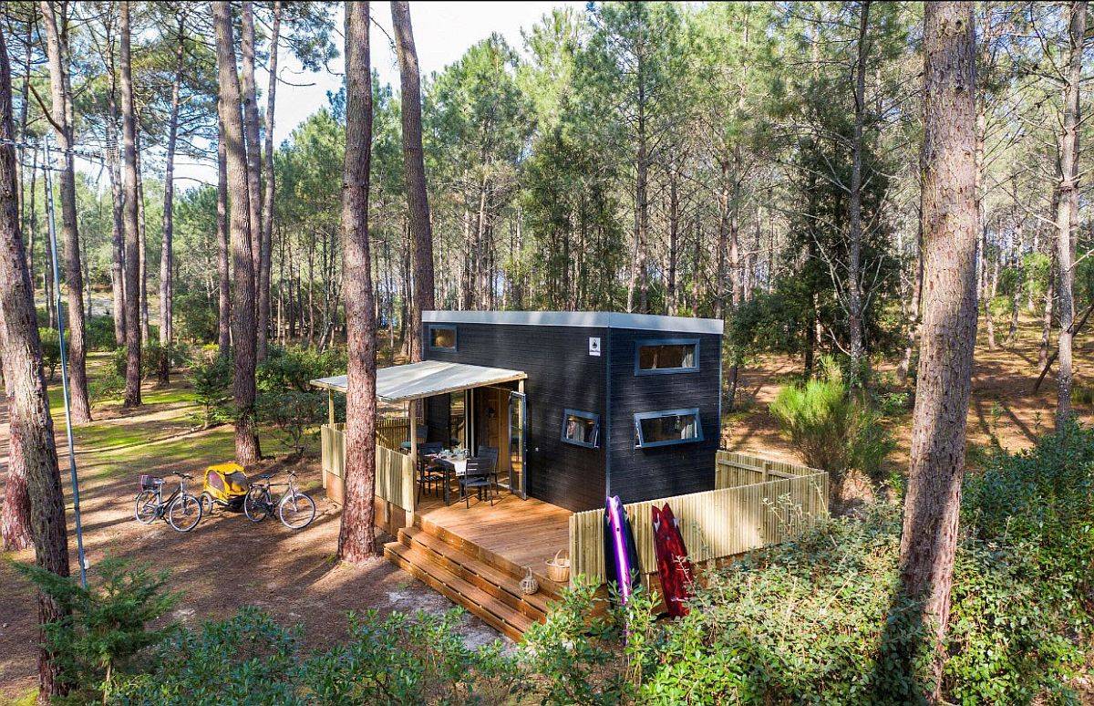 Small and space-savvy wooden cabin in the forest with custom nets that offer additional sleeping areas