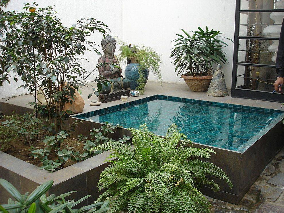 Small courtyard with greenery and a lovely water feature cools your home down on a hot summer day