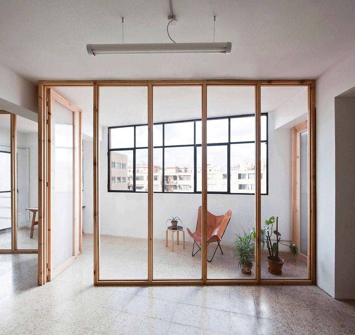 Space between the window walls and the wooden partitions serves as the covered outdoor area!