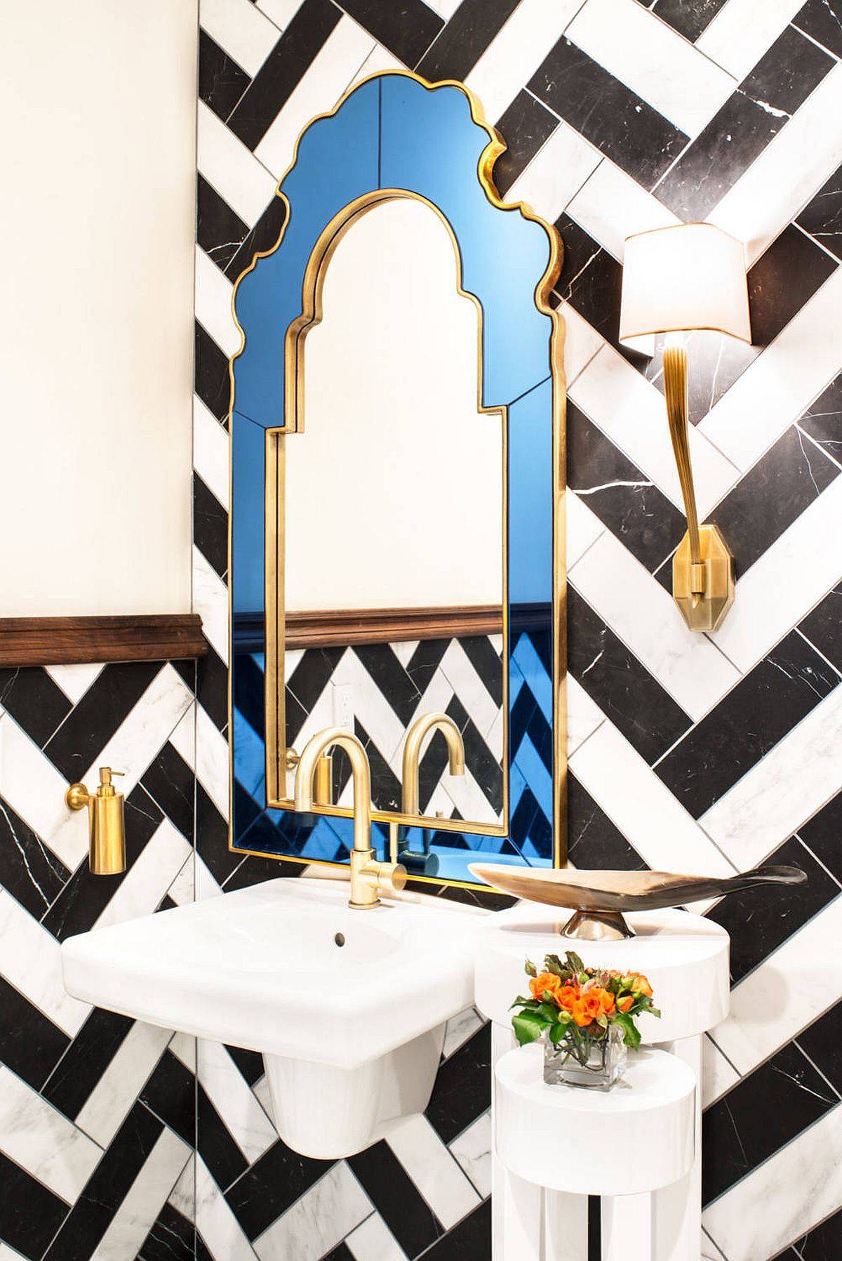 Tiles arranged in the powder room create a black and white chevron pattern