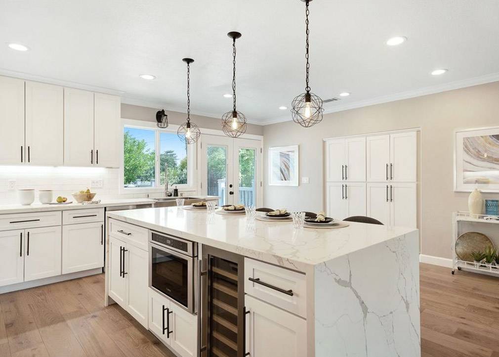 White Cabinets with Metallic Chandeliers.