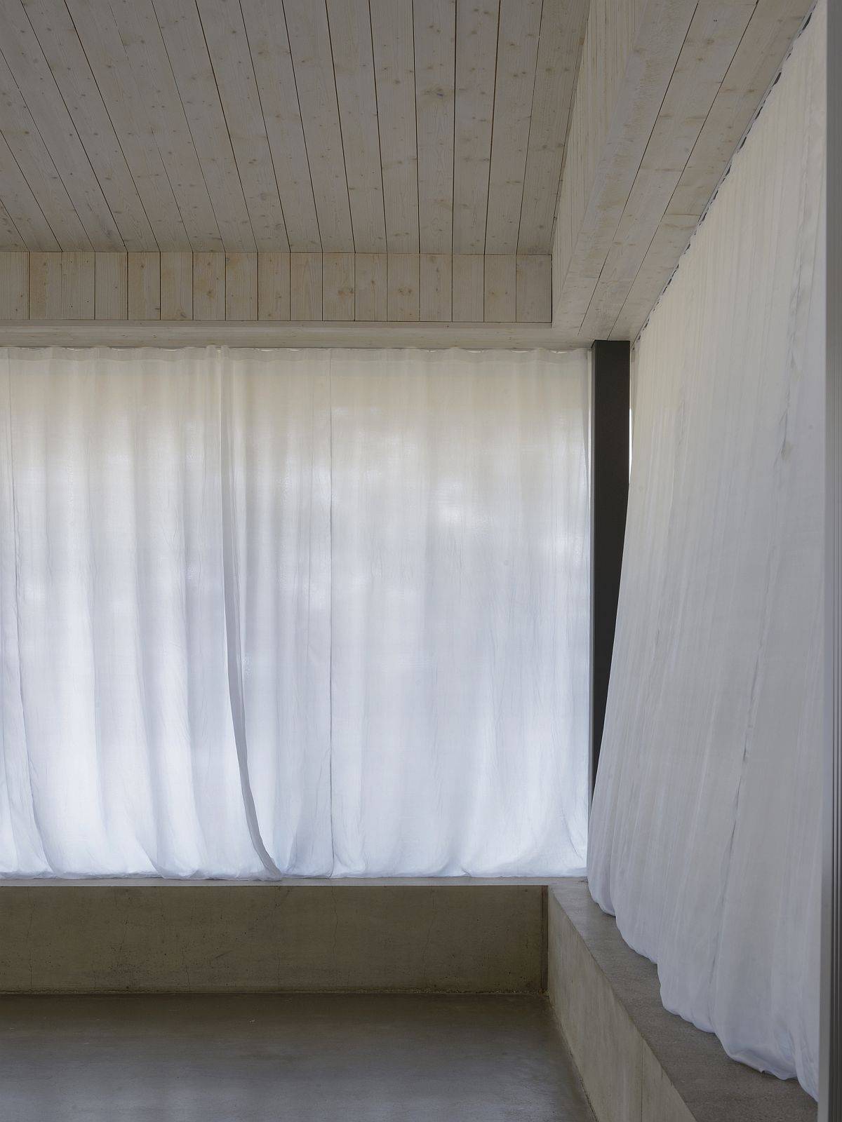 White sheer curtains block out the light from outside on sunny days