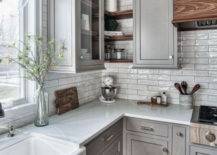 grey granite countertops against grey cabinets and white backsplash