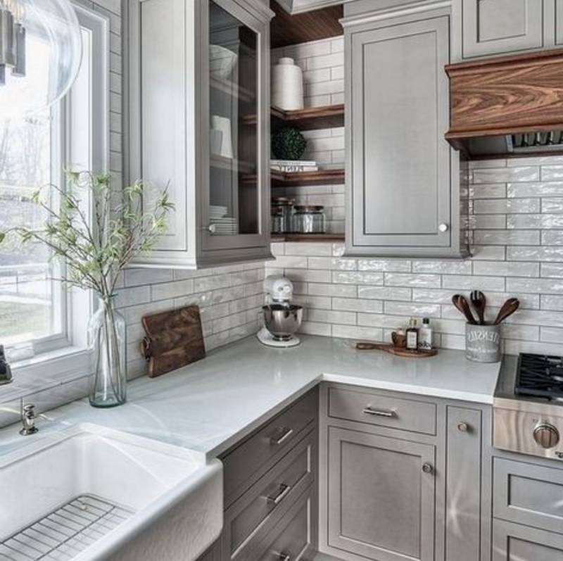 grey granite countertops against grey cabinets and white backsplash