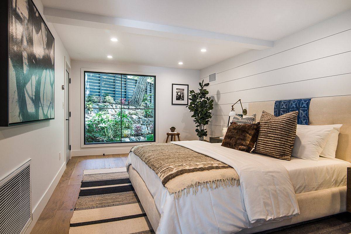 Bedroom below the ground level with garden outside the large window