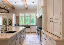 cream kitchen cabinets with light speckled granite countertops