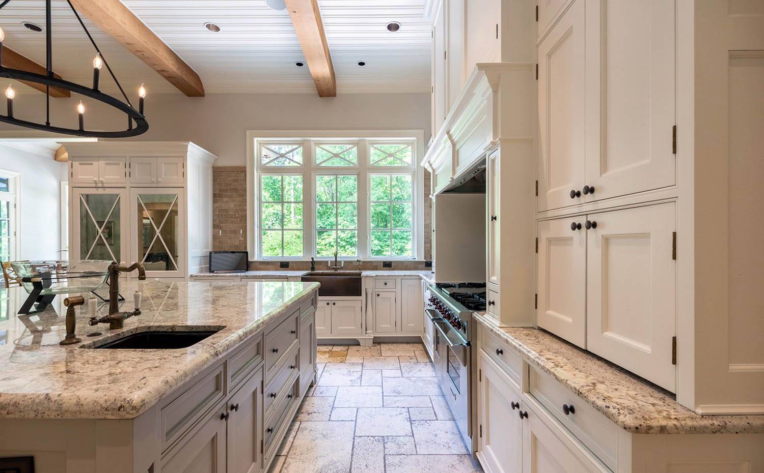 cream kitchen cabinets with light speckled granite countertops