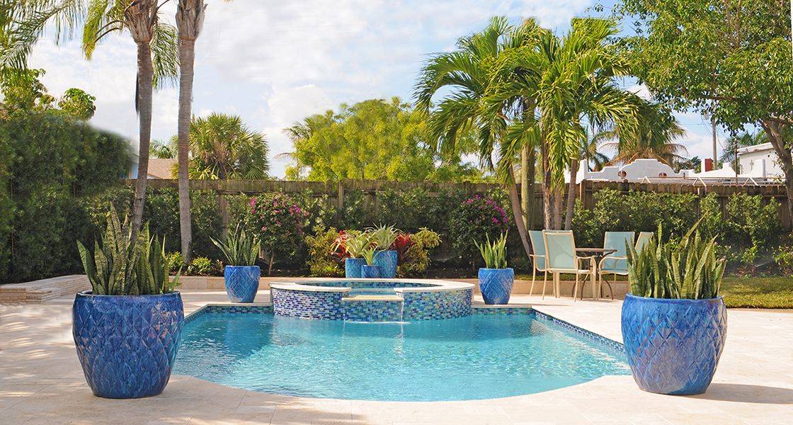 four blue planters on pool patio