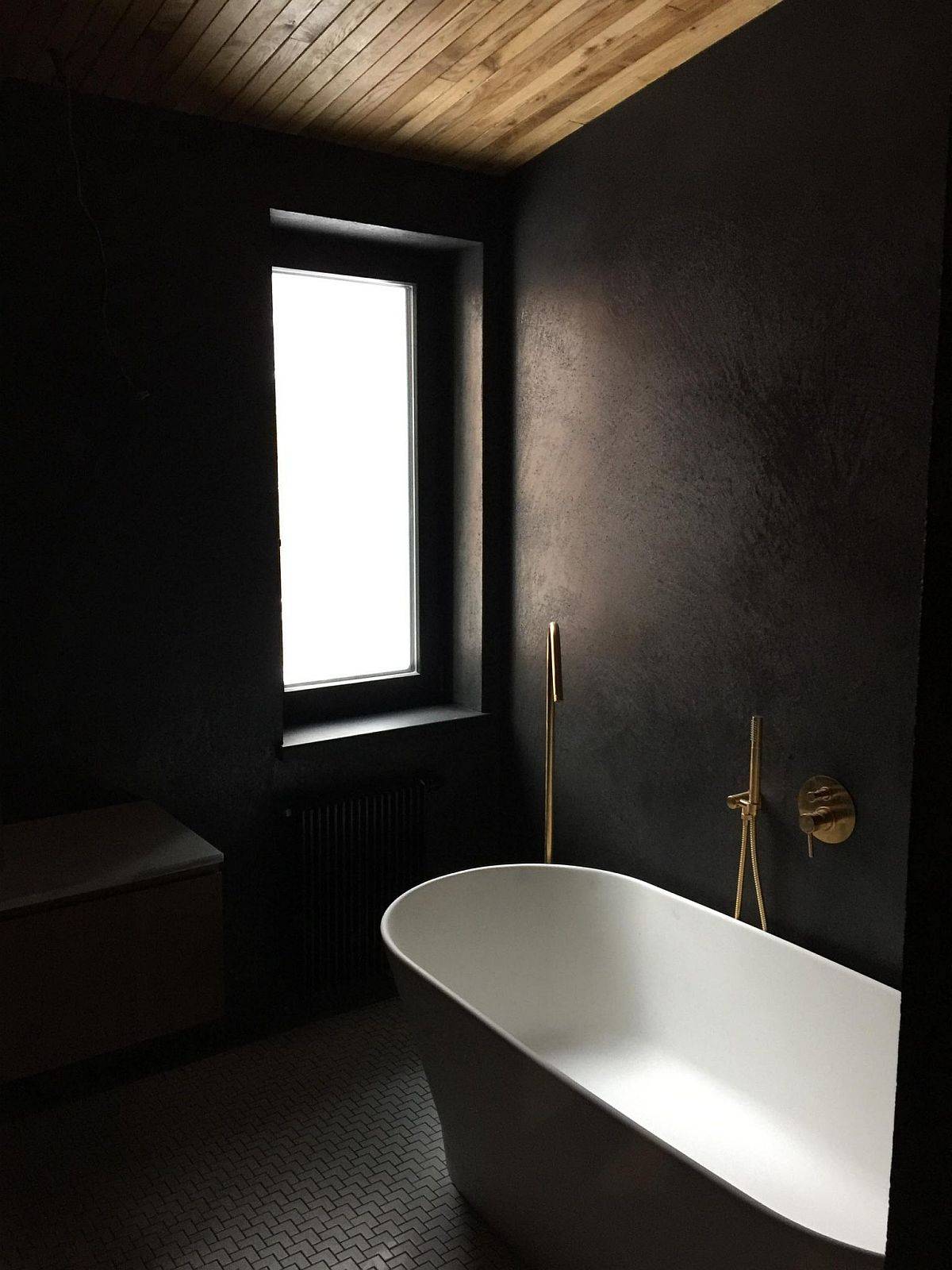 modern bathroom of the home in black and white with a wooden ceiling