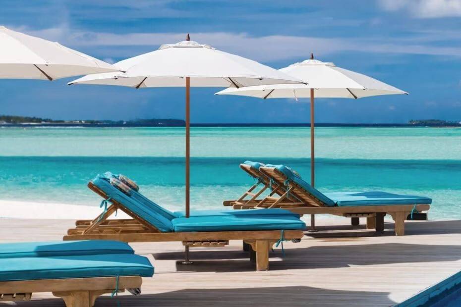 white patio umbrella on deck covering lounger