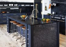 navy blue kitchen island and cabinets with gold fixtures