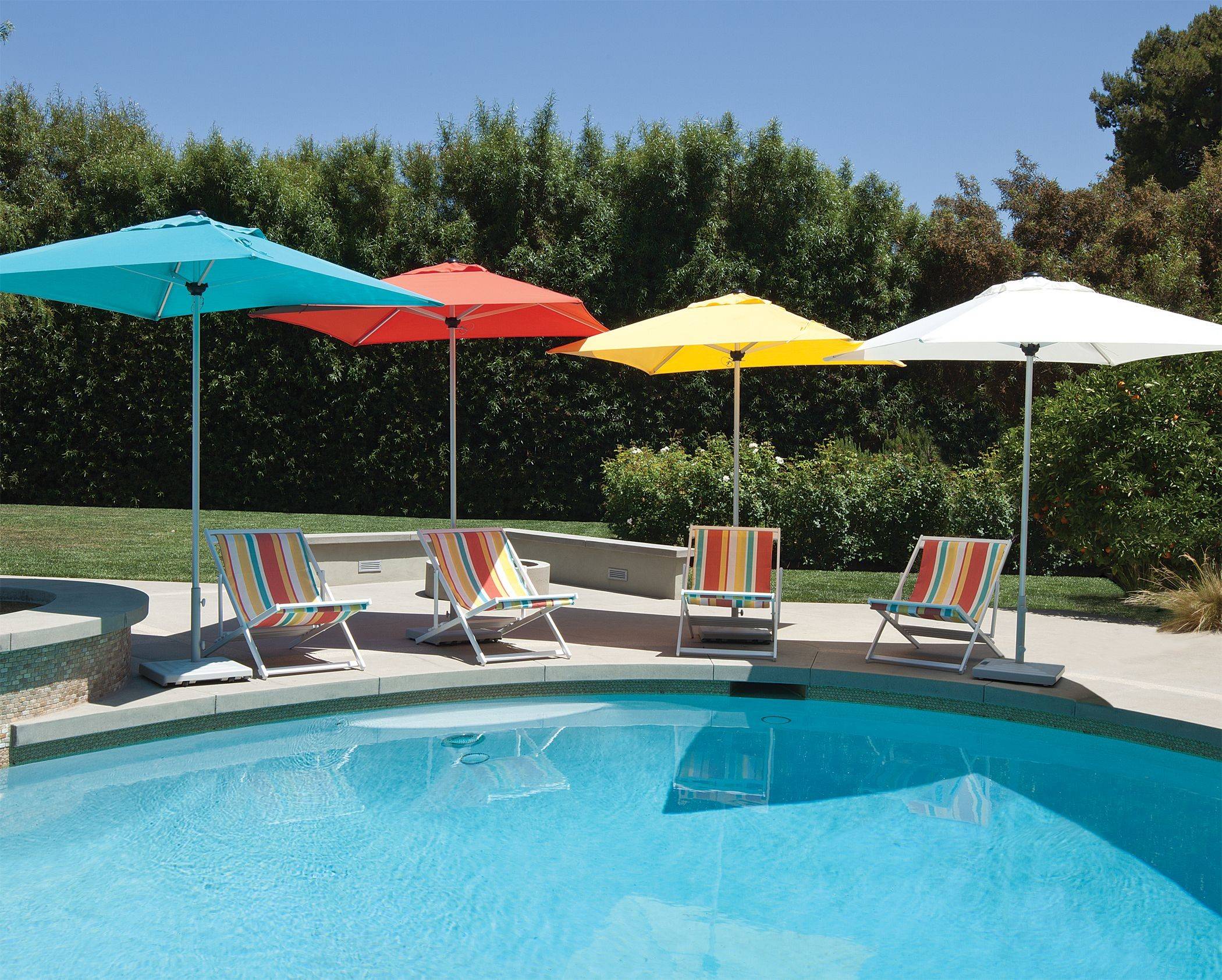 multicolored patio umbrellas by pool