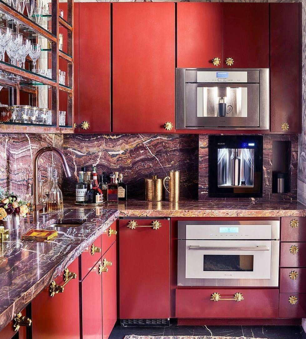 deep red kitchen cupboards with multicolored granite