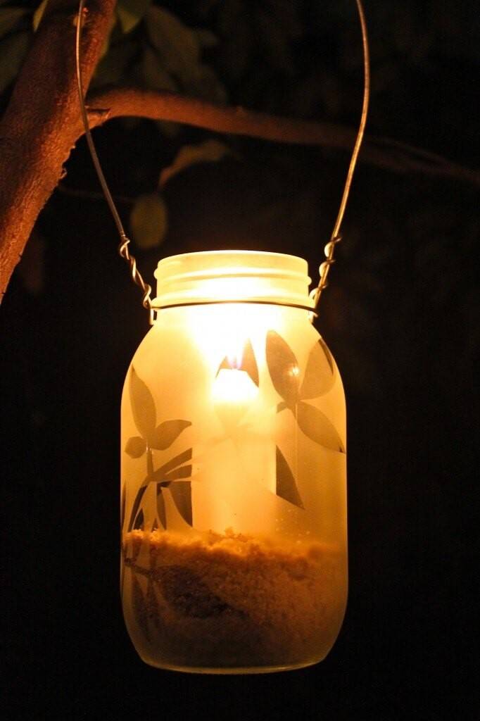 mason jar lantern hanging from tree