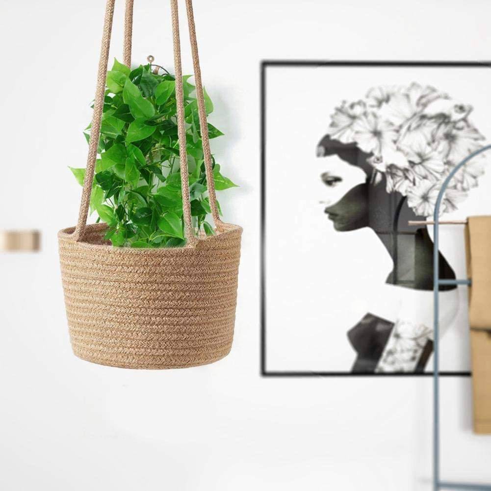 vibrant green plant hanging in wicker basket planter with painting