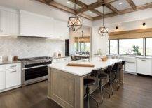 wooden family style kitchen island with chevron marble backsplash