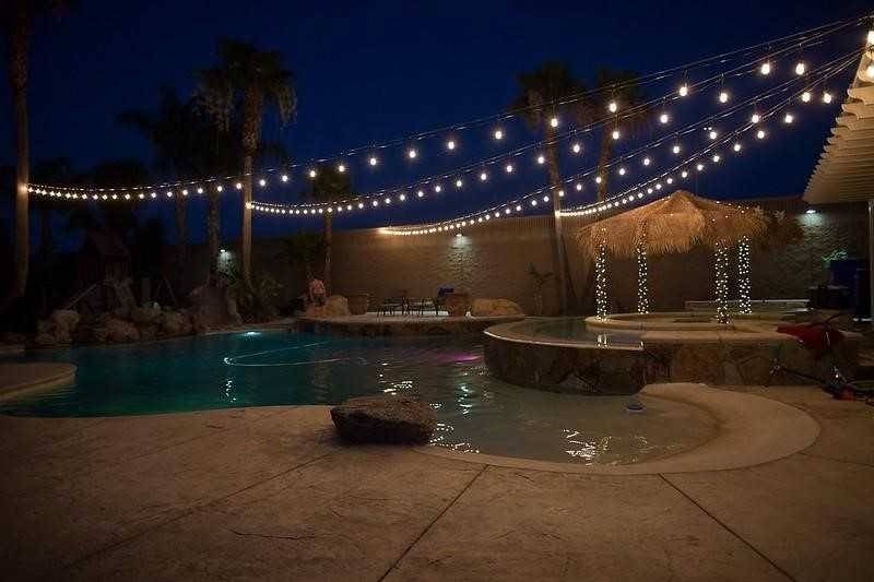 pool at night with string lights overhead