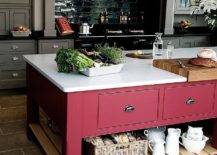 red kitchen island with bright white countertops