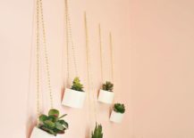 wooden planters hanging on peach wall