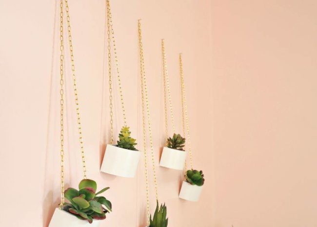 wooden planters hanging on peach wall