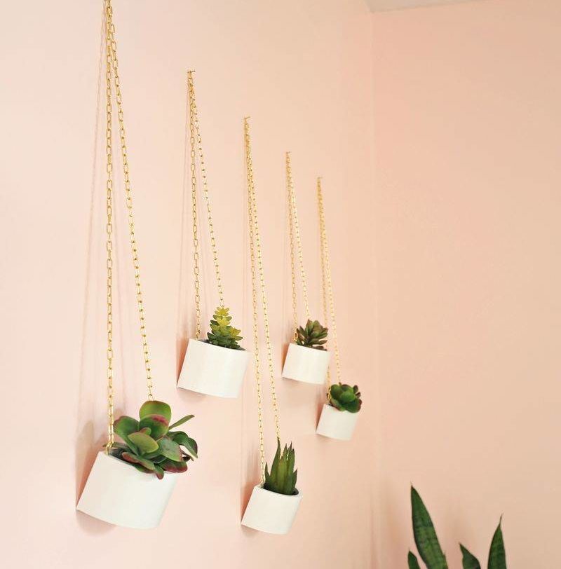 wooden planters hanging on peach wall