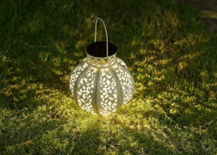 solar lantern glowing on grass