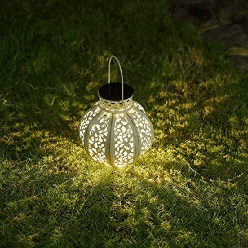 solar lantern glowing on grass