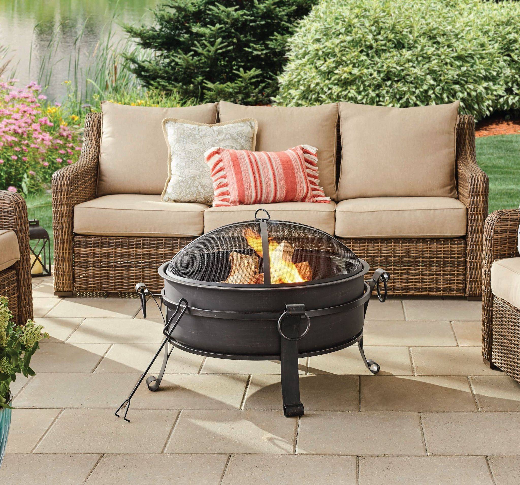 lit firepit with beige outdoor couch