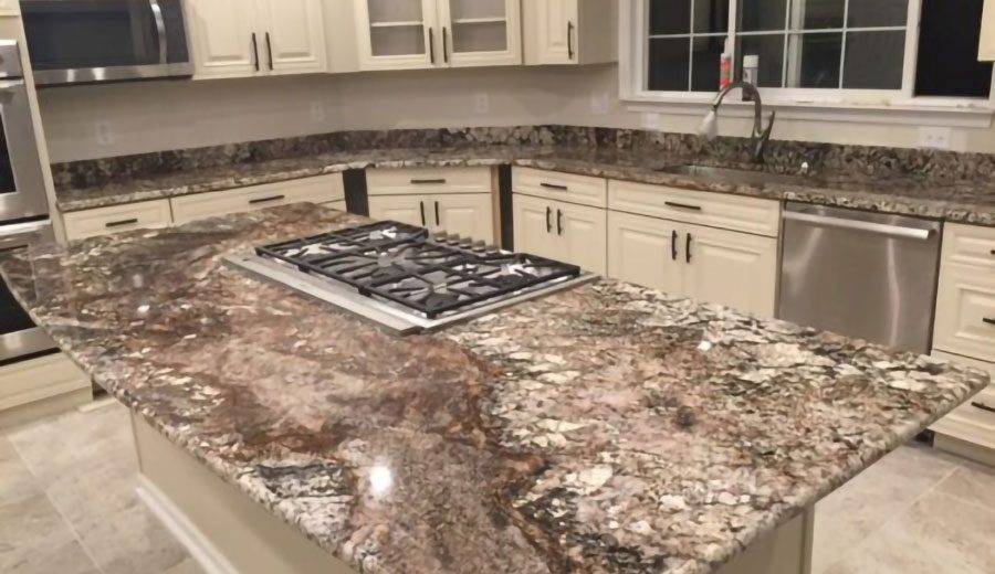 Brown granite countertop with spots of white and grey.