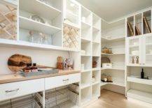 well organized walk-in pantry with different sizes of shelves