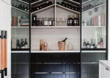walk-in pantry with a unique arrangement for wine bottles and drinking glasses