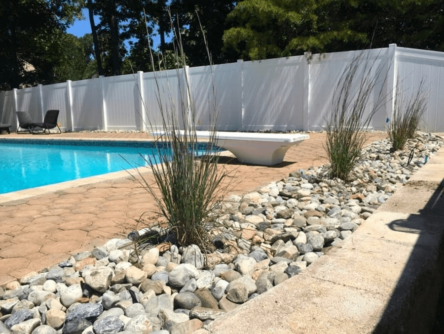 rock garden next to inground pool