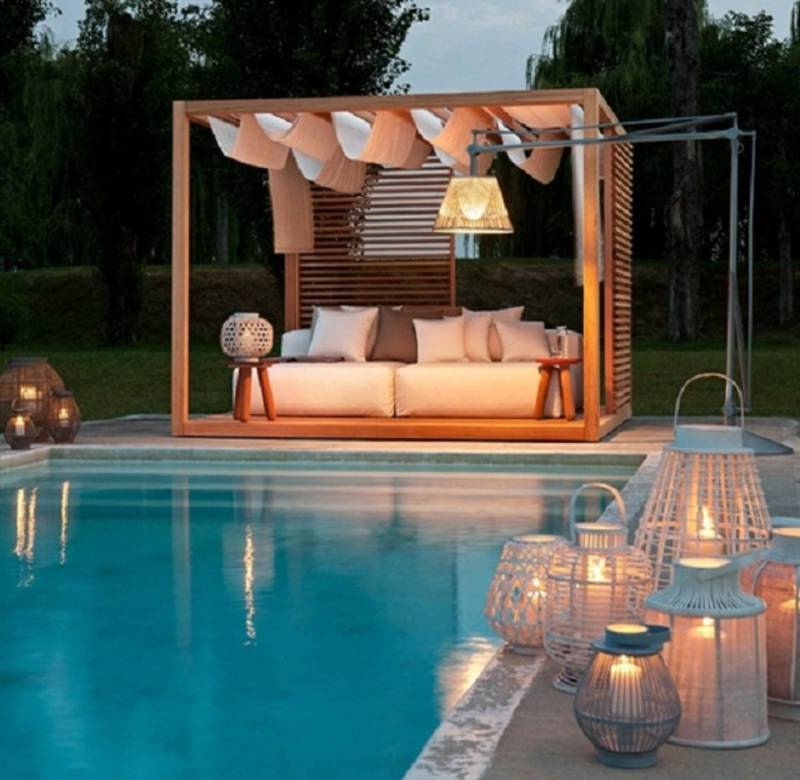 pool gazebo lounge area lit up at night