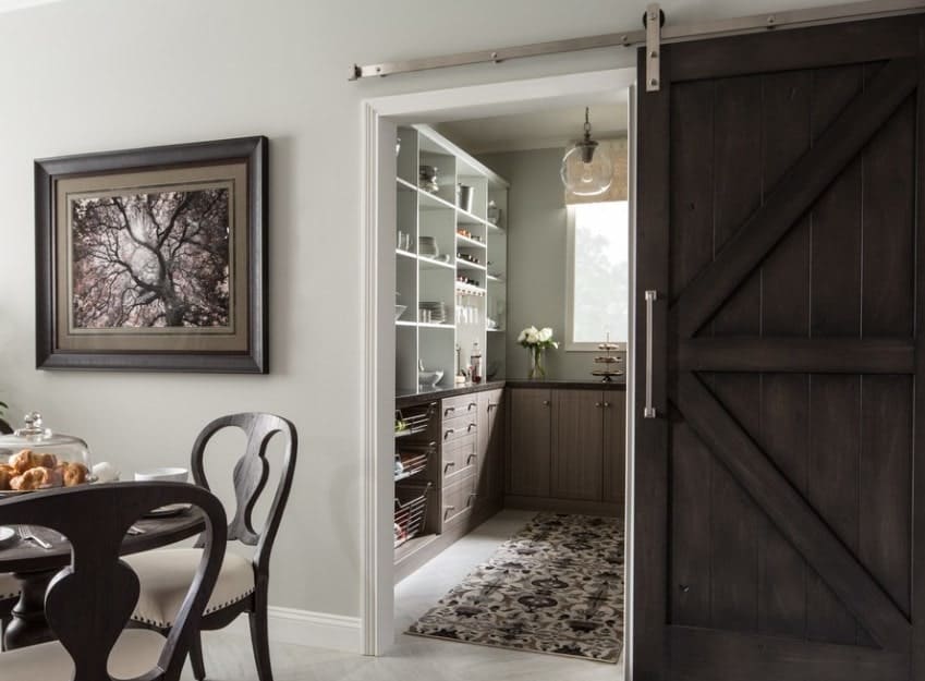 wooden sliding barn door opens into walk in pantry