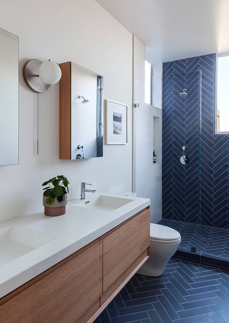 Blue tile in herringbone layout makes the biggest impression in this contemporary bathroom