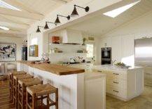 Coastal-style-kitchen-with-sconce-lighting-skylight-breakfast-bar-and-an-island-in-white-72567-217x155