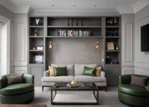 dark gray living room with green leather accent chairs pillows shelf