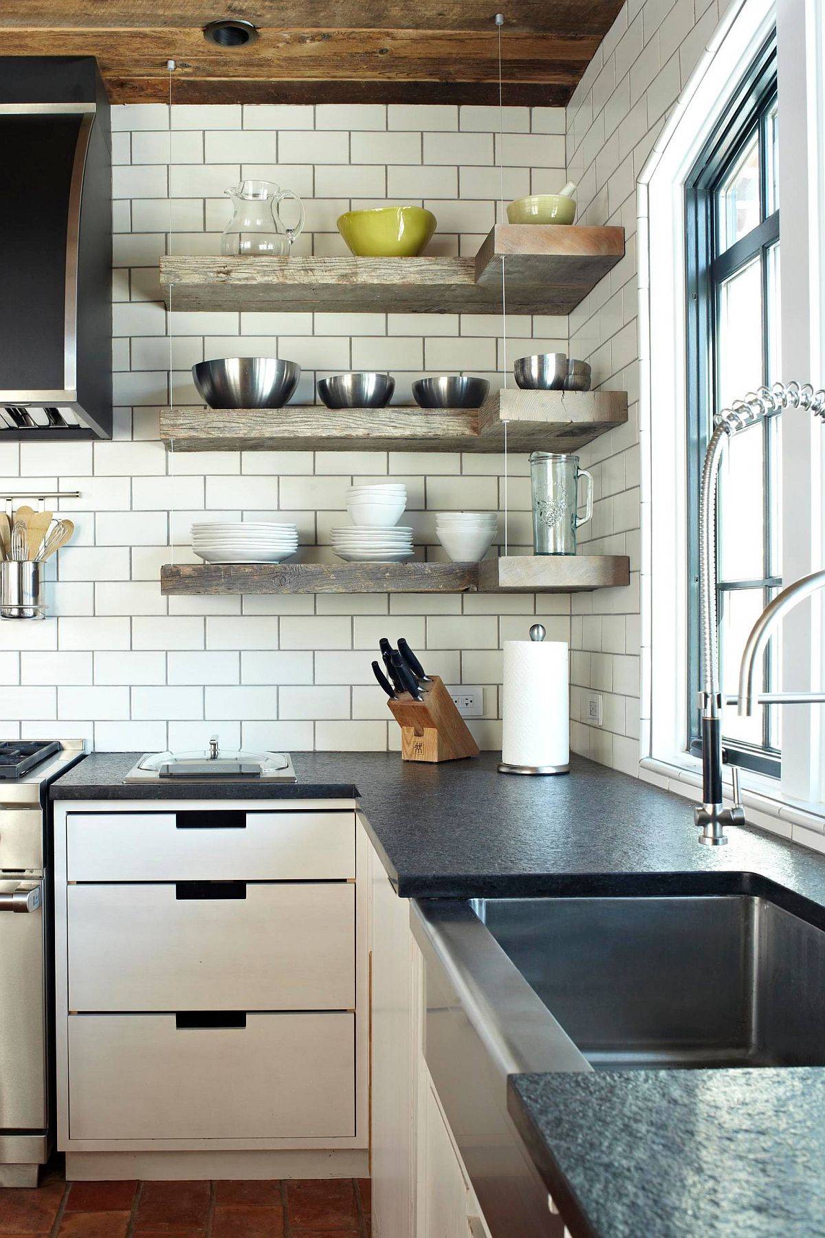 Floating shelves in wood along with cabinets below maximize the corner in this kitchen