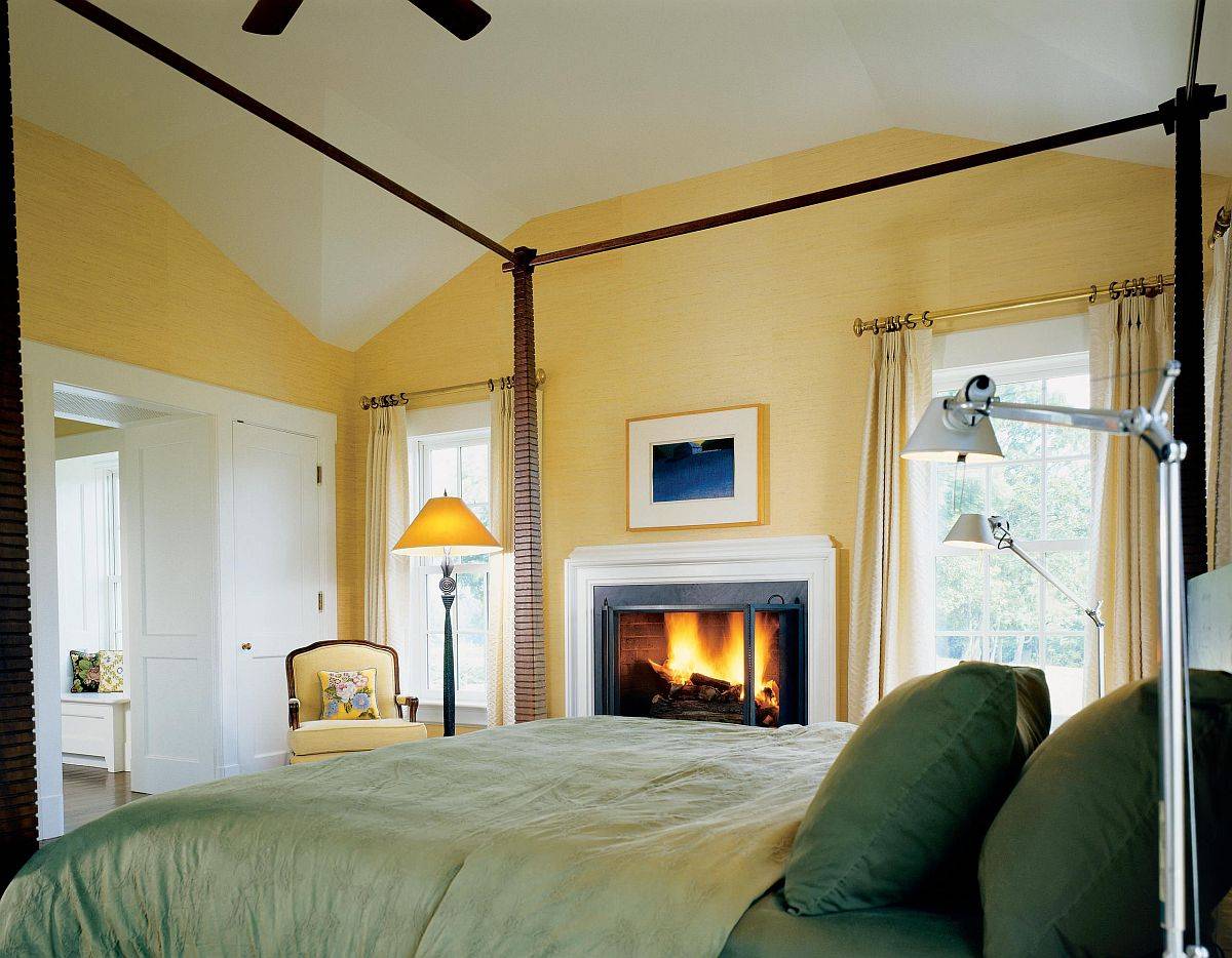 Grasscloth wallpaper in yellow and bedding in green bring color to this cozy bedroom