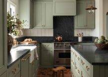 green kitchen cupboards with black onyx countertops