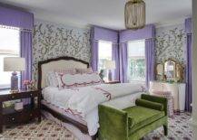 master bedroom with white bed purple curtains green seatee at end