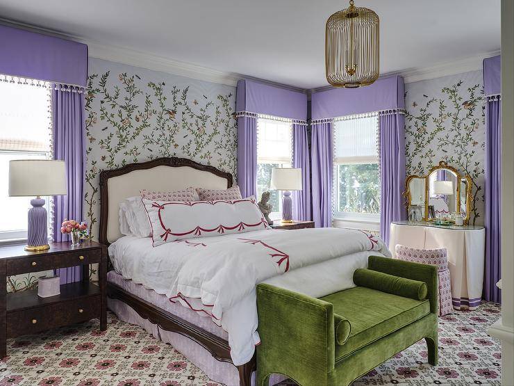 master bedroom with white bed purple curtains green seatee at end