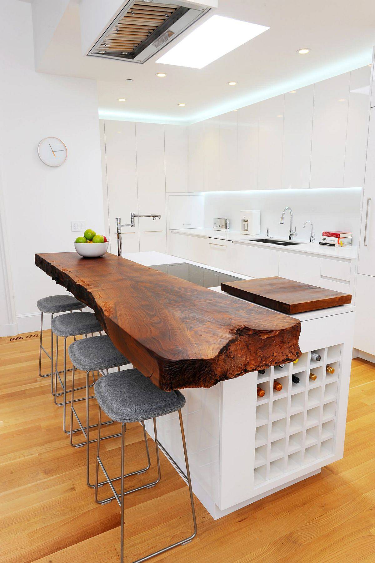 Polished contemporary kitchen in white and wood with a fabulous live-edge breakfast bar