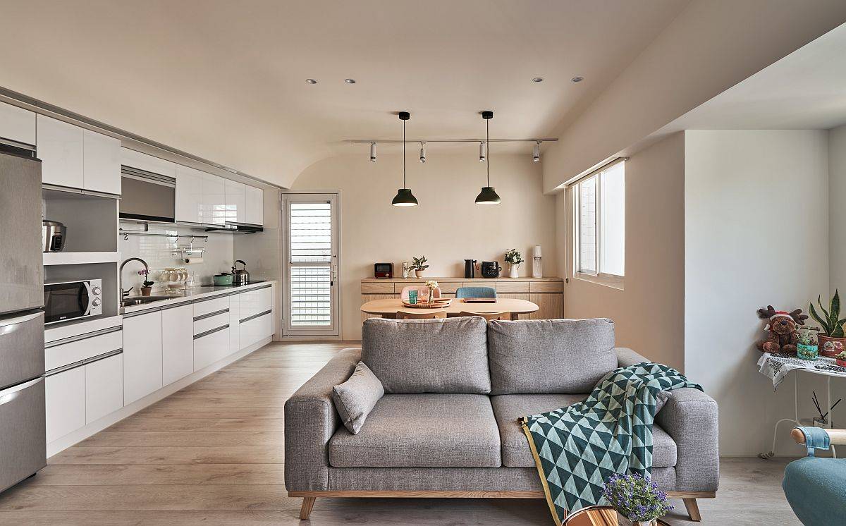 Single-wall kitchen of the contemporary apartment in Taipei with small dining area next to it