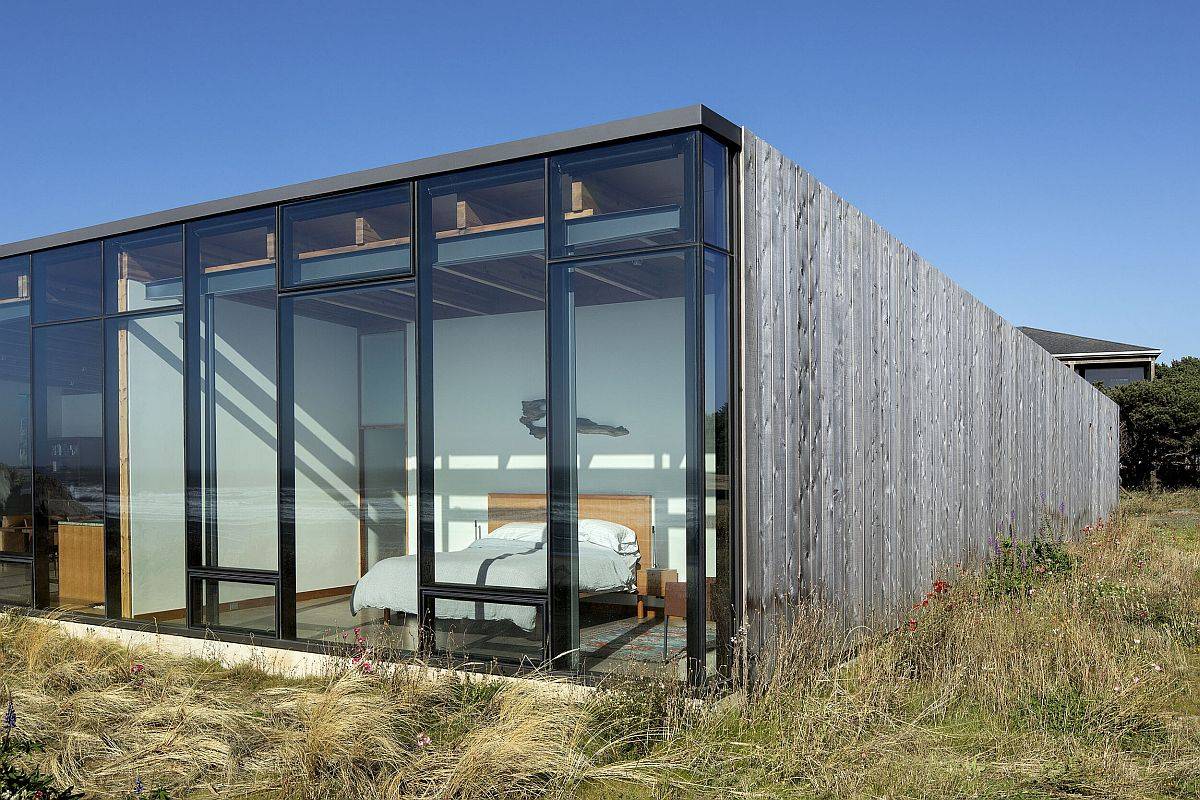 Wall of glass doors and floor-to-ceiling glass windows opens up the ebdrooms to spectacular becah views